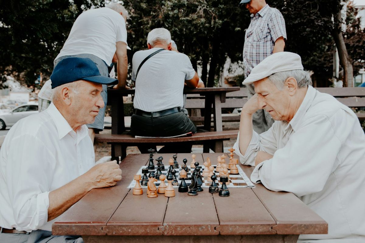 Two older men enjoying a game of chess